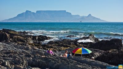 Umbrella on the rocks at Bloubergstrand