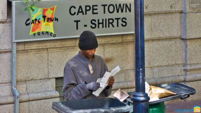 Homeless people looking for food in buckets in Georges Mall in Cape Town